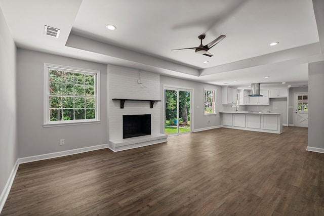989 Lee Road 0213, Phenix City, AL 36870 - unfurnished living room with a raised ceiling, a ceiling fan, dark wood finished floors, a fireplace, and recessed lighting