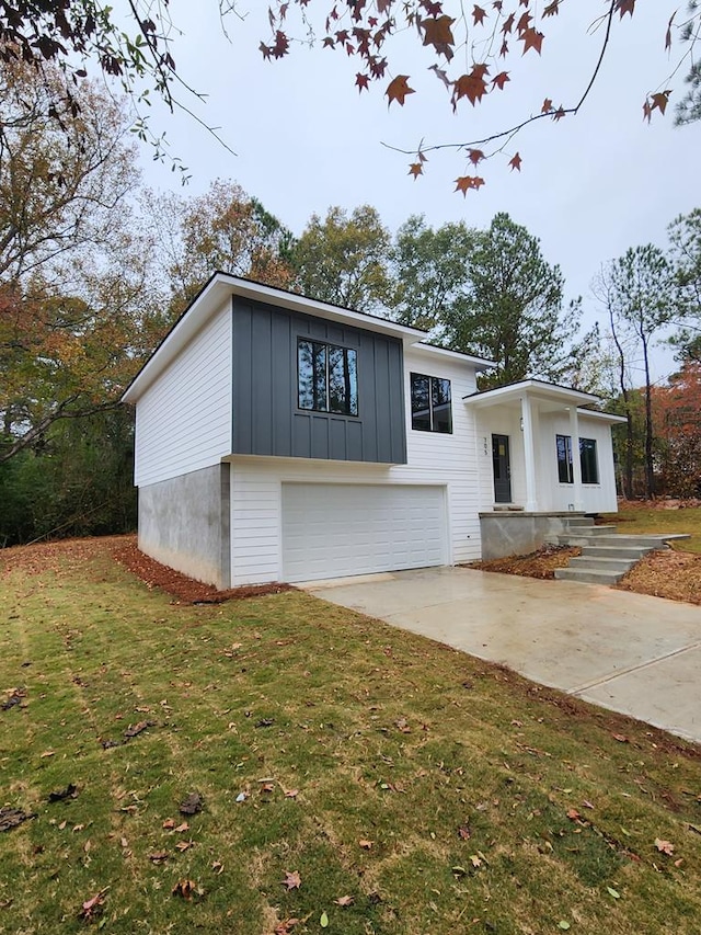 view of front of property with a front yard and a garage