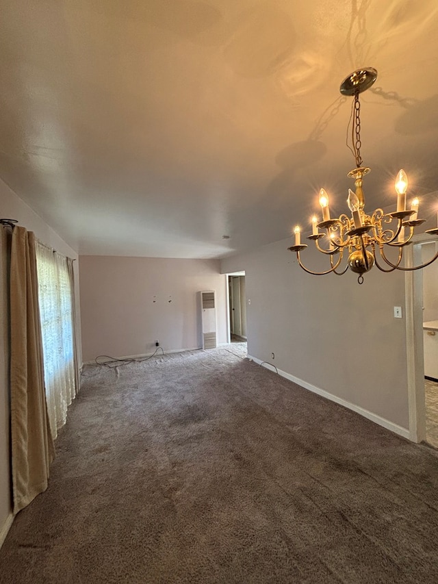 unfurnished room with carpet and a chandelier