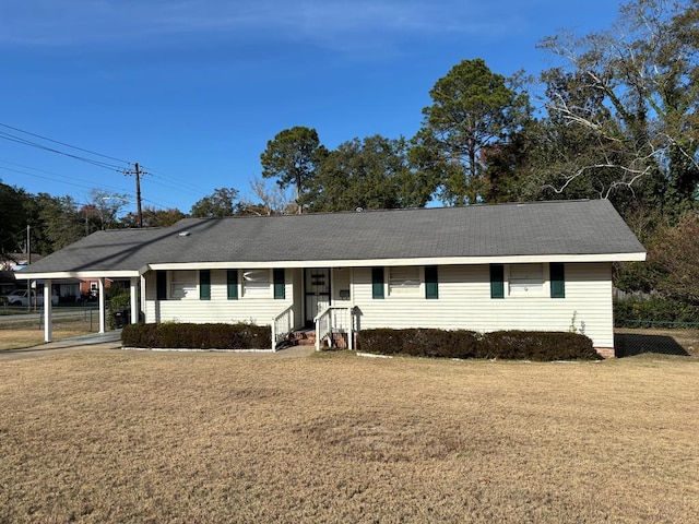 ranch-style home featuring a front yard and a carport