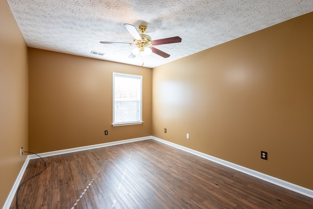 spare room featuring ceiling fan, a textured ceiling, wood finished floors, visible vents, and baseboards