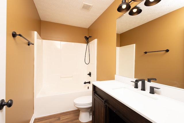 bathroom with visible vents, a textured ceiling, toilet, and vanity