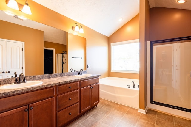 bathroom with lofted ceiling, a garden tub, visible vents, and a sink