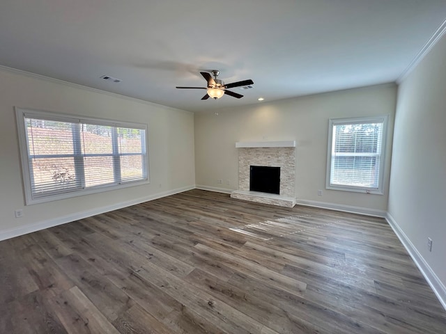 unfurnished living room featuring ornamental molding, a healthy amount of sunlight, and dark hardwood / wood-style floors