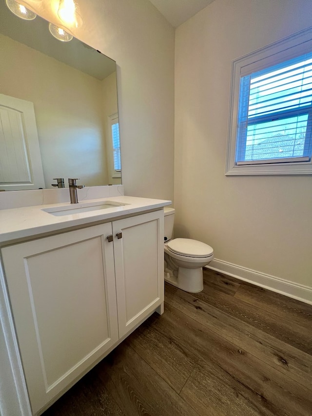 bathroom with vanity, hardwood / wood-style floors, and toilet