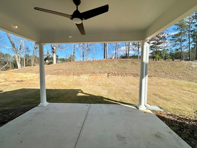 view of yard with ceiling fan and a patio area