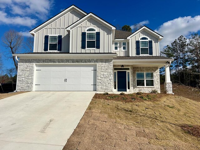 view of front of property featuring a front yard and a garage