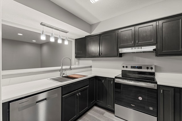 6344 Olde Towne Dr, Columbus, GA 31907 - kitchen featuring stainless steel appliances, under cabinet range hood, dark cabinets, and light countertops