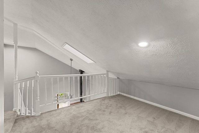 6344 Olde Towne Dr, Columbus, GA 31907 - additional living space with vaulted ceiling, a skylight, carpet flooring, and a textured ceiling