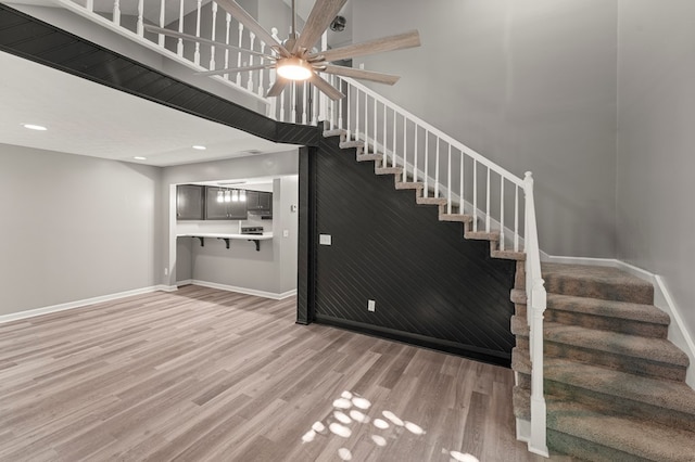6344 Olde Towne Dr, Columbus, GA 31907 - stairway featuring wood finished floors, a ceiling fan, and a towering ceiling