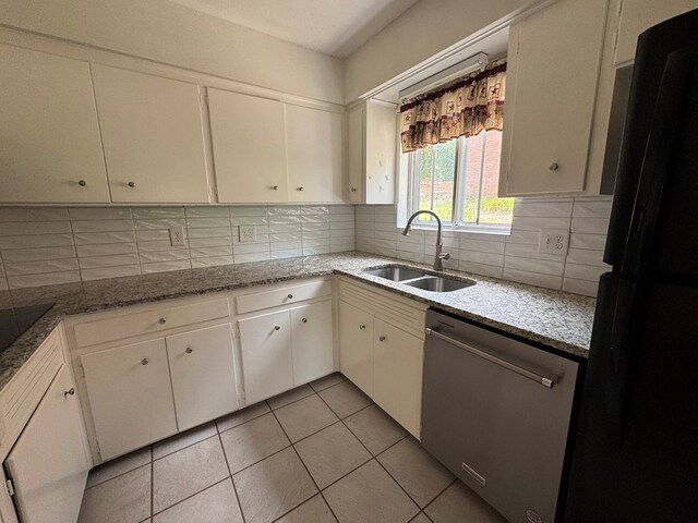 3328 College Ave, Columbus, GA 31907 - kitchen with black appliances, decorative backsplash, light tile patterned flooring, white cabinets, and light stone counters