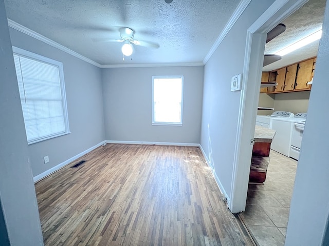 427 Bernard Dr, Columbus, GA 31903 - unfurnished room with washer and dryer, light wood finished floors, ceiling fan, a textured ceiling, and ornamental molding