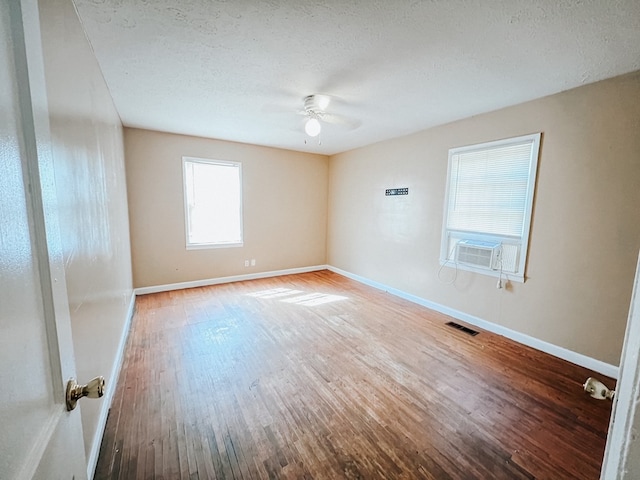 427 Bernard Dr, Columbus, GA 31903 - empty room featuring wood finished floors, a ceiling fan, a textured ceiling, and cooling unit