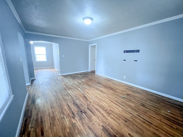 427 Bernard Dr, Columbus, GA 31903 - empty room with arched walkways, a textured ceiling, wood-type flooring, and crown molding