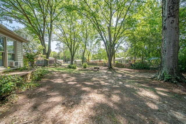 view of yard with fence and cooling unit