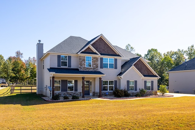 craftsman inspired home with a front lawn and covered porch