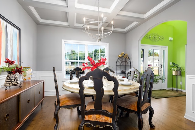 dining room featuring beam ceiling, an inviting chandelier, dark wood-type flooring, and coffered ceiling