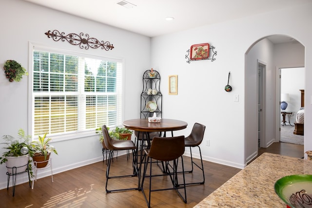 dining area with dark wood-type flooring