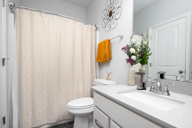 bathroom featuring tile patterned flooring, vanity, and toilet