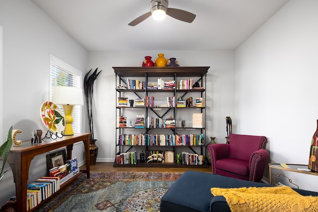 living area with ceiling fan and dark hardwood / wood-style floors