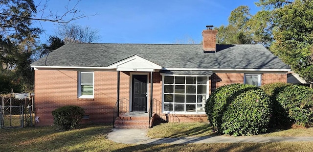 cape cod home featuring brick siding, a shingled roof, a chimney, crawl space, and a front yard