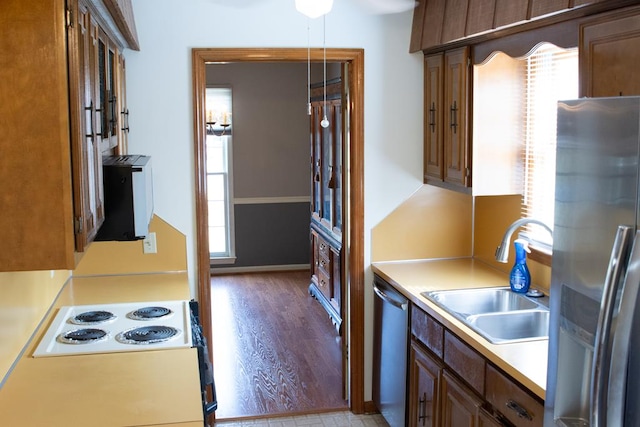 kitchen featuring hardwood / wood-style floors, sink, and stainless steel appliances