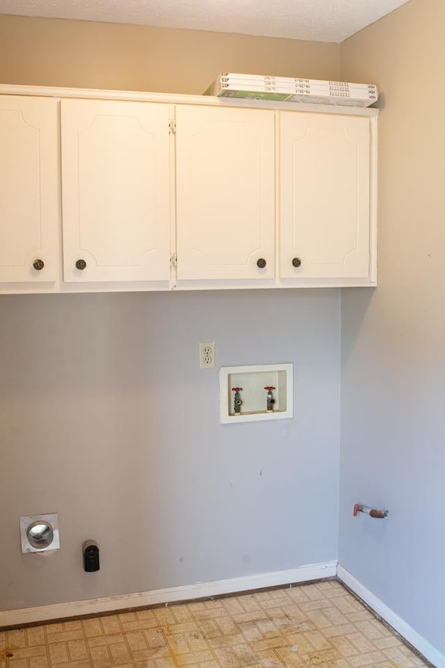 washroom featuring hookup for a gas dryer, cabinets, washer hookup, and hookup for an electric dryer