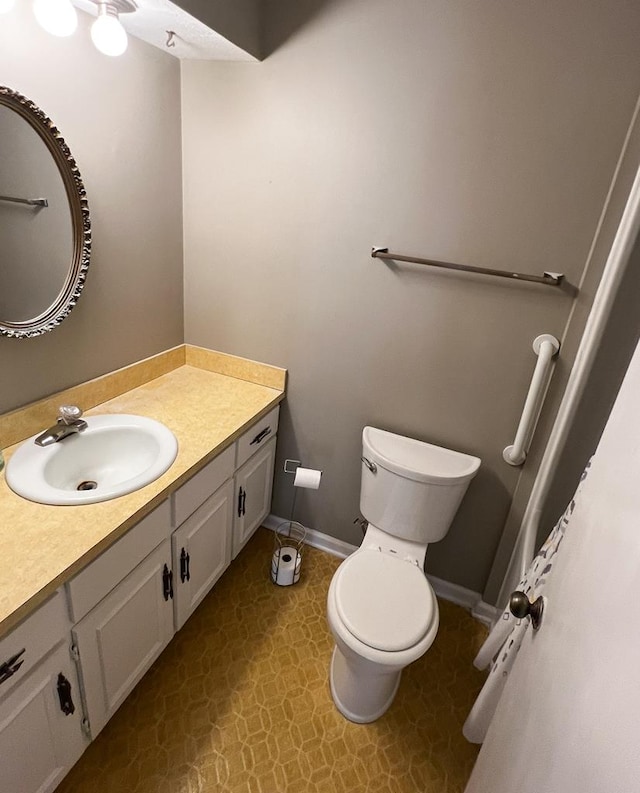 bathroom featuring vanity and toilet