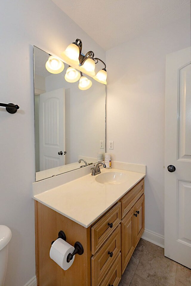7177 Helen Dr, Columbus, GA 31904 - half bath with vanity, toilet, baseboards, and tile patterned flooring