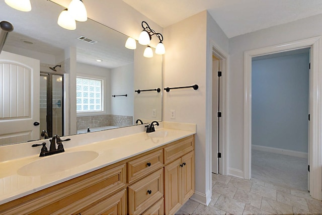 7177 Helen Dr, Columbus, GA 31904 - bathroom featuring double vanity, a stall shower, a bath, baseboards, and stone finish floors