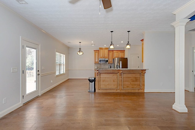 7177 Helen Dr, Columbus, GA 31904 - kitchen with stainless steel appliances, ornate columns, a ceiling fan, ornamental molding, and light wood-type flooring