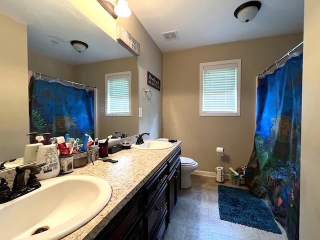 19 Pebblebrook Ln, Fort Mitchell, AL 36856 - bathroom with plenty of natural light, double vanity, and a shower with shower curtain