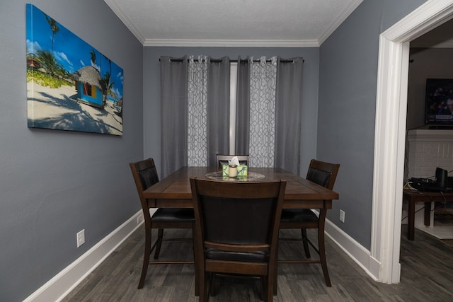 dining space featuring a textured ceiling, dark wood-type flooring, and ornamental molding