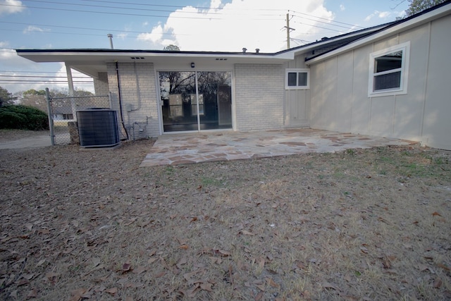 rear view of house with central AC and a patio