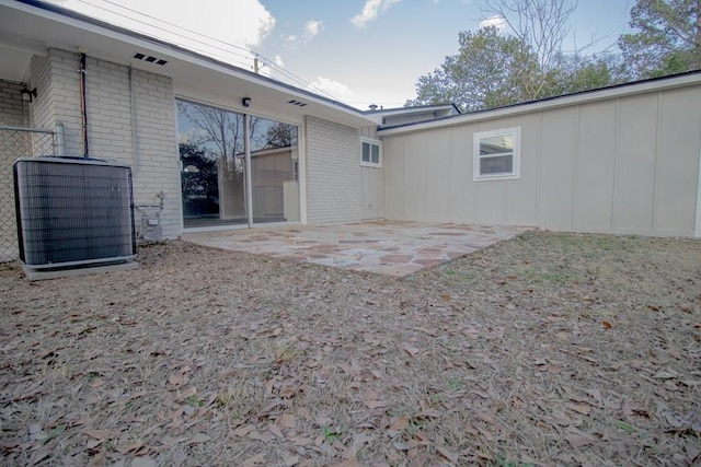 view of yard featuring central AC and a patio