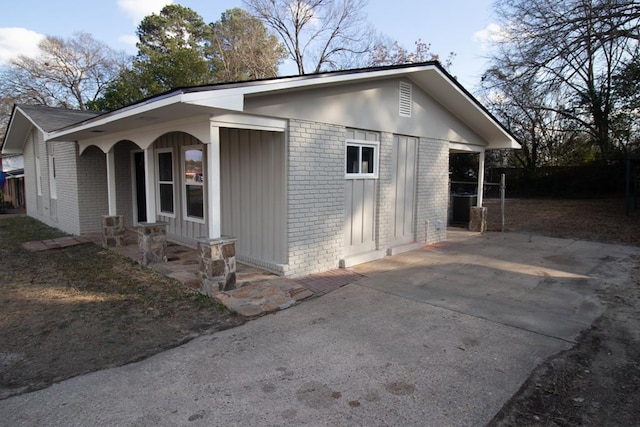 view of side of home with covered porch