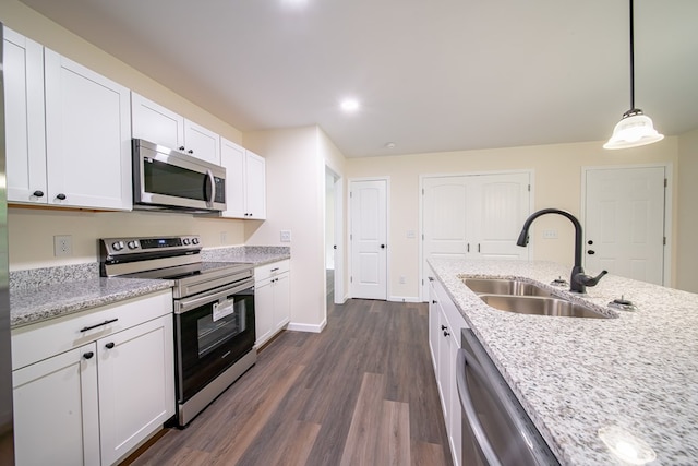 6900 Forrest Rd, Columbus, GA 31907 - kitchen with appliances with stainless steel finishes, dark wood-style flooring, white cabinetry, decorative light fixtures, and light stone countertops