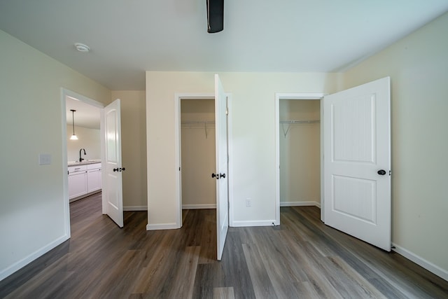 6900 Forrest Rd, Columbus, GA 31907 - unfurnished bedroom featuring dark wood finished floors and two closets