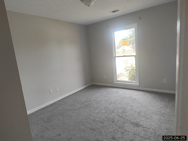 6123 Caribou Dr, Columbus, GA 31907 - carpeted empty room with baseboards and a textured ceiling