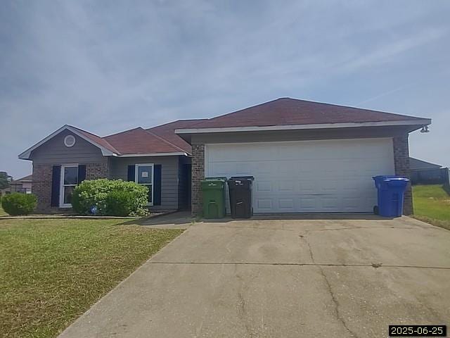 6123 Caribou Dr, Columbus, GA 31907 - single story home with a front yard, concrete driveway, and a garage