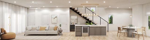 bar with stairs, light wood finished floors, stainless steel dishwasher, and recessed lighting