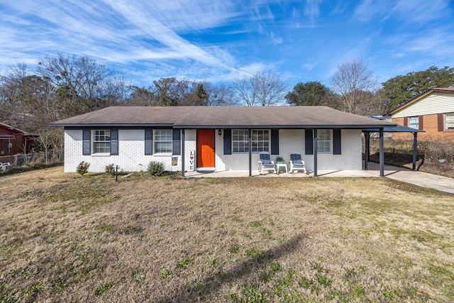 ranch-style house with a carport, a front lawn, and covered porch