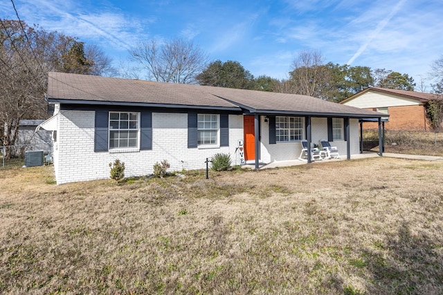 ranch-style home with a front yard and central air condition unit