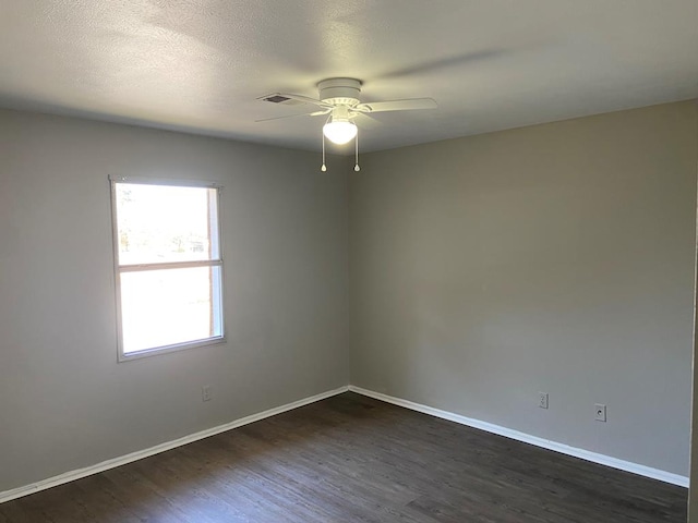 spare room featuring dark hardwood / wood-style flooring and ceiling fan