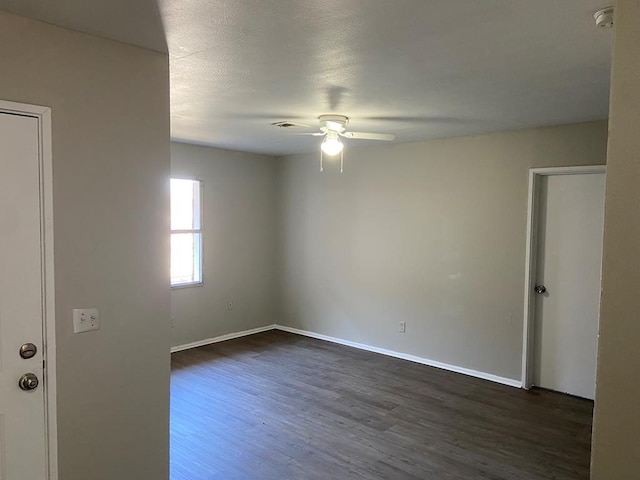 spare room featuring ceiling fan and dark hardwood / wood-style flooring