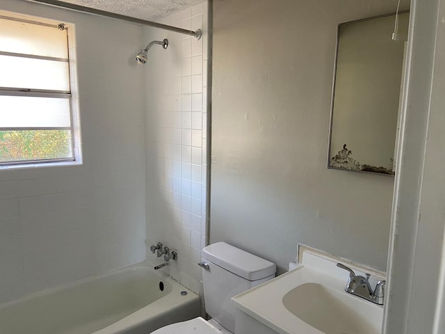 full bathroom featuring toilet, vanity, and tiled shower / bath