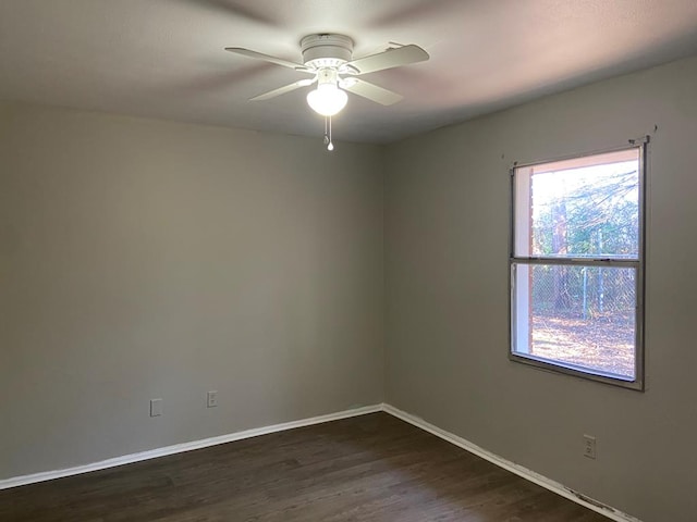 empty room featuring ceiling fan and dark hardwood / wood-style flooring