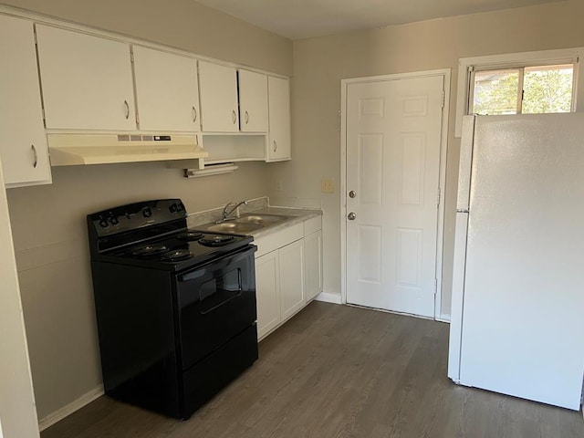 kitchen featuring white cabinets, white refrigerator, sink, black electric range, and dark hardwood / wood-style flooring