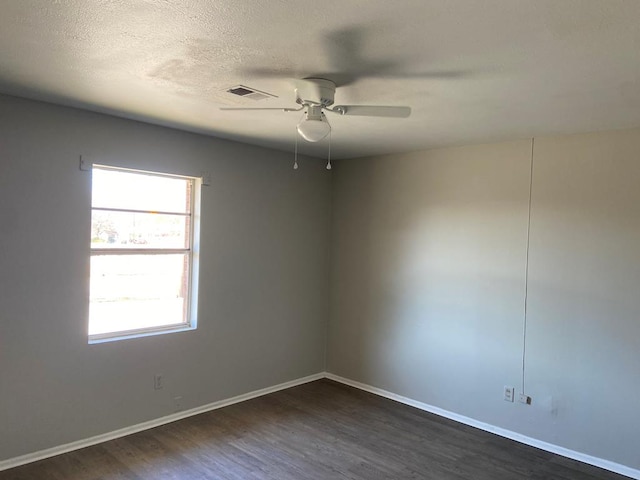 unfurnished room with a textured ceiling, dark hardwood / wood-style flooring, and ceiling fan