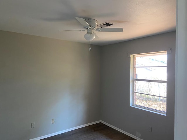 spare room with ceiling fan and dark hardwood / wood-style floors